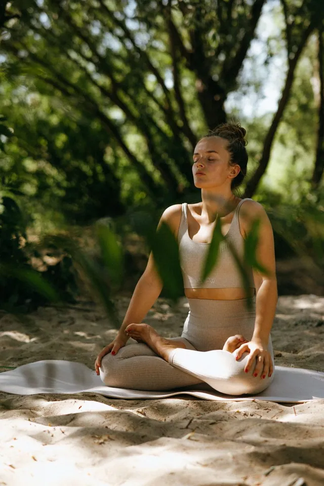 A member meditating peacefully outdoors